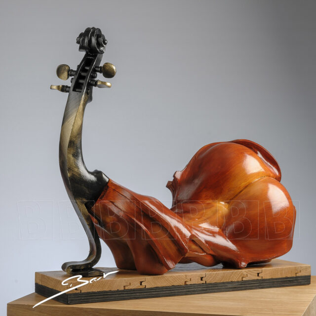 Surrealistic sculpture combining a violin and a woman in one shape, titled Miss Chief